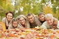 Happy smiling family relaxing in autumn park