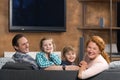 Happy Smiling Family Sitting On Couch In Living Room, Parents Couple With Two Children Royalty Free Stock Photo