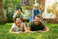 Happy smiling family with two children lying in the home backyard garden grass Royalty Free Stock Photo