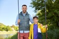 Happy smiling father and son fishing on river Royalty Free Stock Photo