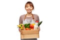 happy smiling female chef with food in wooden box Royalty Free Stock Photo