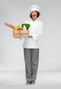 Happy smiling female chef with food in wooden box Royalty Free Stock Photo