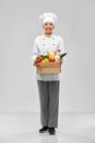 happy smiling female chef with food in wooden box Royalty Free Stock Photo