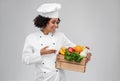 happy smiling female chef with food in wooden box Royalty Free Stock Photo