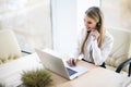 Happy smiling female customer support phone operator at workplace. Royalty Free Stock Photo