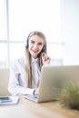 Happy smiling female customer support phone operator at workplace. Royalty Free Stock Photo