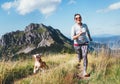 Happy smiling female jogging by the mounting range path with her beagle dog. Canicross running healthy lifestyle concept image Royalty Free Stock Photo