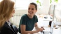 Happy smiling female trainee discussing business ideas with adult trainer Royalty Free Stock Photo