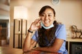 Happy smiling filipina nurse on phone