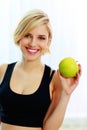 Happy smiling fit woman holding green apple Royalty Free Stock Photo