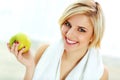 Happy smiling fit woman holding green apple Royalty Free Stock Photo