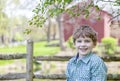 Boy on farm standing under a tree Royalty Free Stock Photo