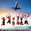 Happy smiling friends jumping on the beach with an aircraft on the sky Royalty Free Stock Photo