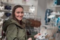 Happy smiling girl buys Slippers at home lingerie store