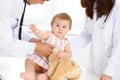 Happy smiling girl-child at usual medical inspection. Doctor and female toddler patient in the clinic. Medicine concept Royalty Free Stock Photo