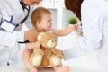 Happy smiling girl-child at usual medical inspection. Doctor and female toddler patient in the clinic. Medicine concept Royalty Free Stock Photo