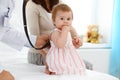 Happy smiling girl-child at usual medical inspection. Doctor and female toddler patient in the clinic. Medicine concept Royalty Free Stock Photo