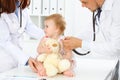 Happy smiling girl-child at usual medical inspection. Doctor and female toddler patient in the clinic. Medicine concept Royalty Free Stock Photo