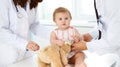 Happy smiling girl-child at usual medical inspection. Doctor and female toddler patient in the clinic. Medicine Royalty Free Stock Photo