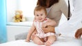 Happy smiling girl-child at usual medical inspection. Doctor and female toddler patient in the clinic. Medicine Royalty Free Stock Photo