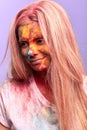 Happy smiling girl with colorful smeared face looking down Royalty Free Stock Photo