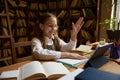 Happy smiling girl elementary student studying online at home Royalty Free Stock Photo