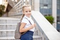 Happy smiling girl is going to school for the first time with bag go to elementary school