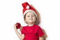 happy smiling girl in holiday clothes and santa claus hat. cute child and christmas decoration Royalty Free Stock Photo