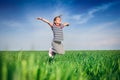 Happy smiling girl jumping at the field of wheat Royalty Free Stock Photo