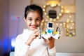 Happy Smiling Girl kid with small DIY robot in Hand looking at camera - Concept of Child Prodigy, Scientific experiment, Knowledge Royalty Free Stock Photo