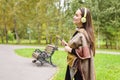 Young happy woman listening music from smartphone with headphones in a quiet Park Royalty Free Stock Photo