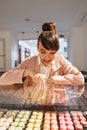 Happy smiling girl looking at pastries through glass showcase Royalty Free Stock Photo