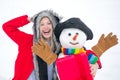 Happy smiling girl make snowman on sunny winter day. Winter weather in park. Winter portrait of funny girl in snow Royalty Free Stock Photo