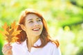 Happy smiling girl with natural red hair. Autumn woman with bright orange hair. Cheerful smiling ginger woman holding Royalty Free Stock Photo