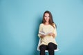 Happy smiling girl reading book and sitting on the chair Royalty Free Stock Photo