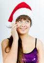 Happy smiling girl with Santa hat with a phone Royalty Free Stock Photo