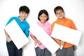Happy smiling group of kids showing blank placard board. Royalty Free Stock Photo
