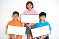 Happy smiling group of kids showing blank placard board. Royalty Free Stock Photo