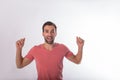 Happy smiling handsome bearded man with arms raised with positive emotions looking in camera Royalty Free Stock Photo