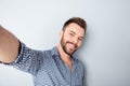 Happy smiling handsome bearded young man making selfie Royalty Free Stock Photo