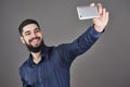 Happy smiling handsome bearded young man making selfie Royalty Free Stock Photo