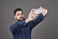 Happy smiling handsome bearded young man making selfie Royalty Free Stock Photo