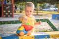 Happy smiling and handsome boy kid having fun playing at playground in a park on bright sunny day Royalty Free Stock Photo