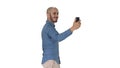 Happy smiling handsome young man making selfie while walking on white background. Royalty Free Stock Photo