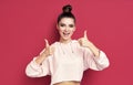 Happy smiling hipster woman showing thumbs up on pink background Royalty Free Stock Photo