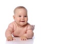 Happy infant child baby girl kid in diaper lying on her tummy, stomach, crawling, touching floor at copy space Royalty Free Stock Photo