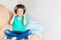 Happy smiling kid boy in headphones listen to music or audiobook Royalty Free Stock Photo