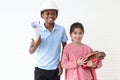 Happy smiling kid engineer African boy with helmet safety hard hat holding blueprint and cute Asian girl holding pile of books Royalty Free Stock Photo