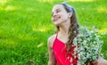 Happy smiling kid girl harvesting organic chamomile flowers