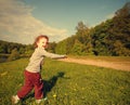 Happy smiling kid girl running on green grass Royalty Free Stock Photo